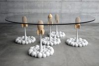 03 the Rocket table brings fluffy, cartoon-like clouds and aerial rockets from a personal toy collection to life
