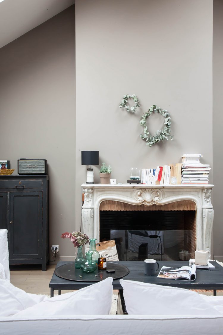 this white fireplace is a renovated vintage piece