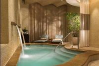 08 tiny indoor pool with two waterfalls and a tiled deck