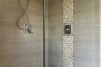 large charcoal shower tiles with a pebble accent