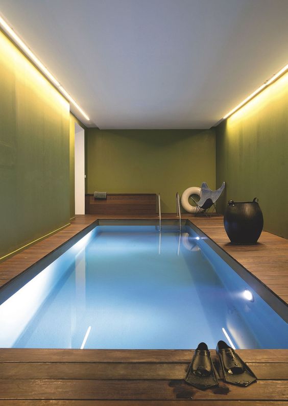 modern simple indoor pool with a wooden deck around