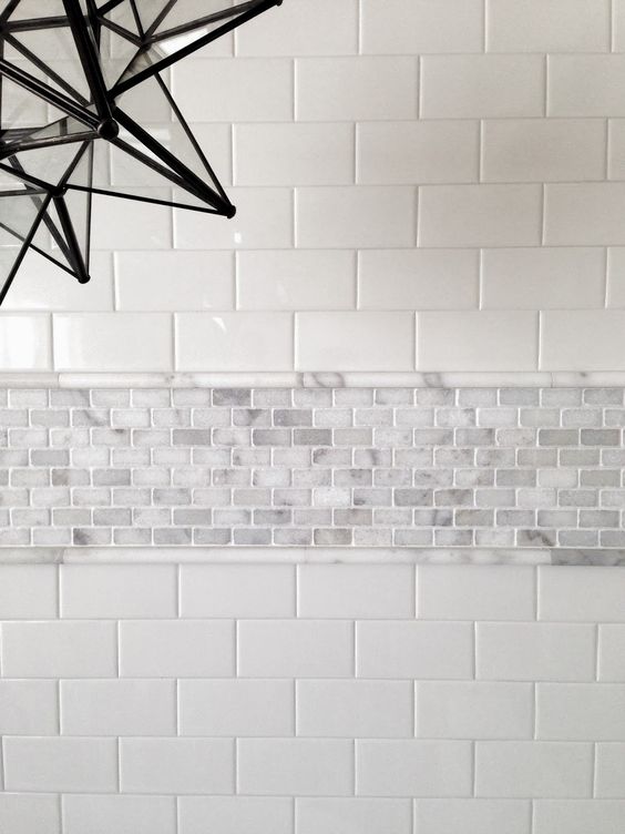 subway tiles accentuated with a tiny marble tiles border