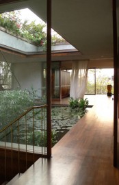 An Indoor Courtyard With A Pond