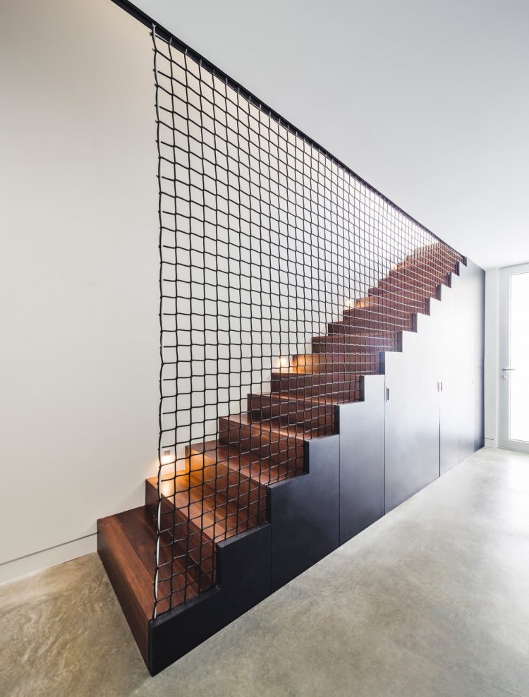 A net over the staircase is an interesting solution to divide the space