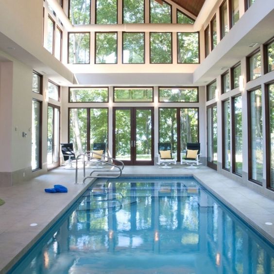 beautiful indoor pool with a marble deck and views