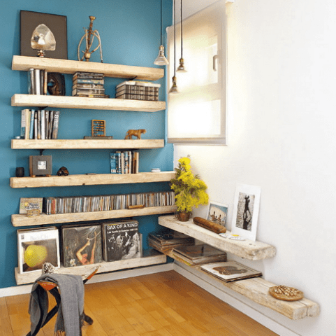light blue accent wall with shelves and accessories