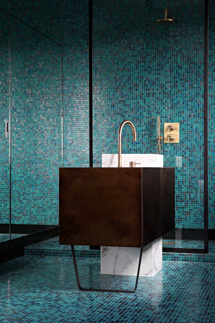 mosaic bathroom tiles contrast with a metal sink stand