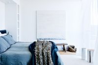 12 The master bedroom is soothing in washed-out blue shades