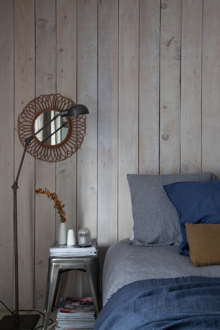 the master bedroom is full of rustic and industrial touches