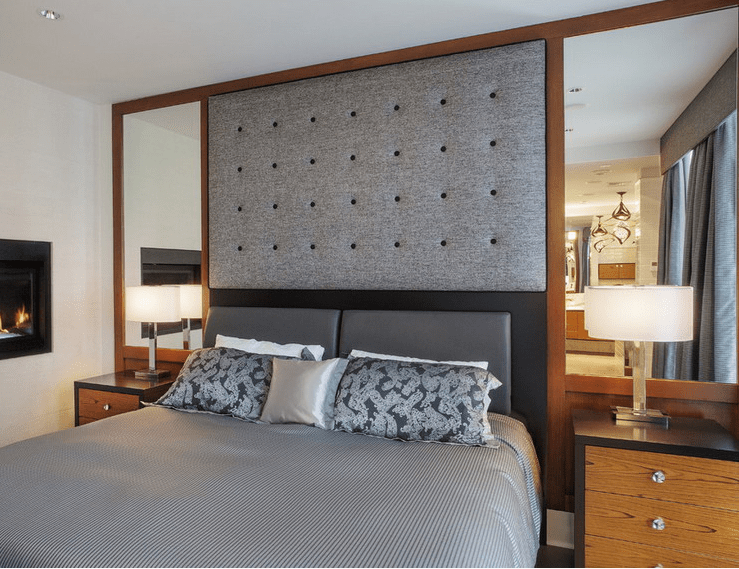 Hollywood-style symmetrical mirrors with a fabric headboard