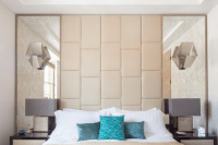 19 symmetrical mirrors with a leather headboard in-between