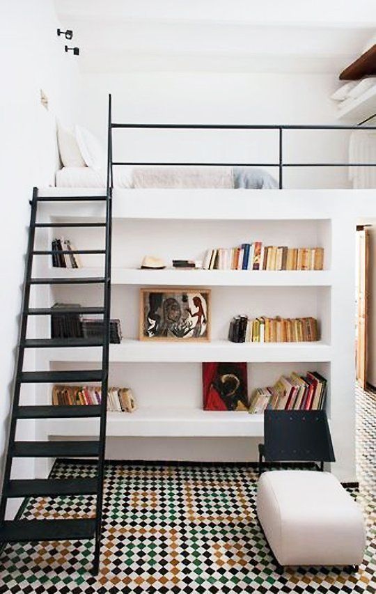 A creative teen room with a loft bedroom and closet and a reading space down with built in shelves and an ottoman