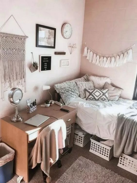a simple teen boho room with a bed and a desk, boxes for storage, a gallery wall with tassels and macrame is cool