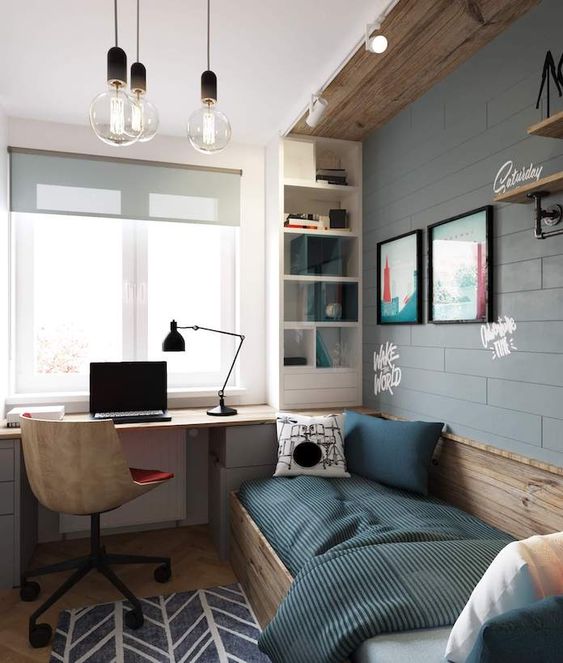 An industrial teen room with a faux brick wall, wooden touches, a bed, a built in desk and a storage shelf plus bulbs
