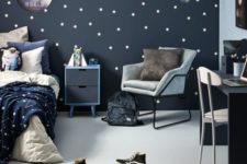 a cool space-themed kid’s room done in navy, grey and white, with a star pattern incorporated and blue and grey furniture
