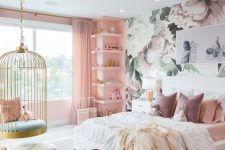 a fantastic girl’s bedroom with a floral accent wall, a pink wall with built-in shelves, a white bed with pink bedding, a cage pendant chair