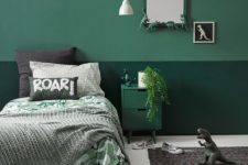 a fun mint and green dinosaur-themed room with greenery, dinos and fun bedding is perfectly styled