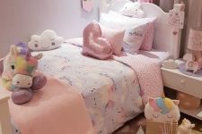 a small and lovely girl’s bedroom with white vintage furniture, a pink curtain and bedding, a pink rug and lots of colorful toys