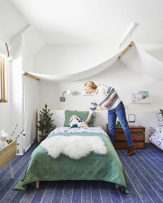 An adventure themed shared kids' room will easily fit both boys and girls thanks to its neutral color scheme