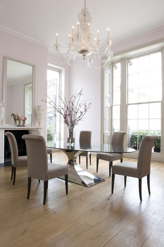 an exquisite modern dining table with a large andstable polished metal base and an oval tabletop is a gorgeous statement for the space