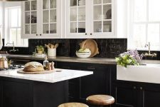 a vintage-inspired kitchen with black shaker cabinets, white countertops and a black Zellige tile backsplash, metal pendant lamps
