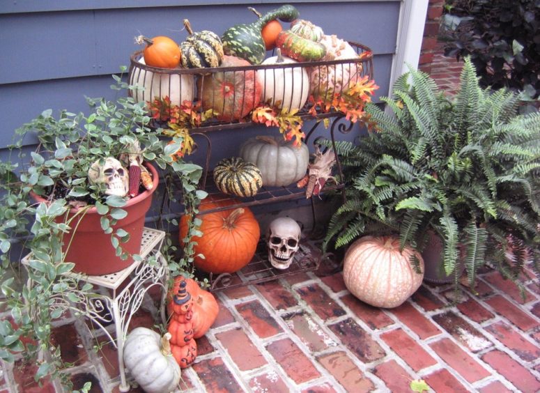 Mixing fall leaves, pumpkins, gourds and Indian corn works great for Fall decorations. Adding several skulls would turn suck display into a Halloween one. A bunch of tea lights would add a spooky vibe on Halloween night.