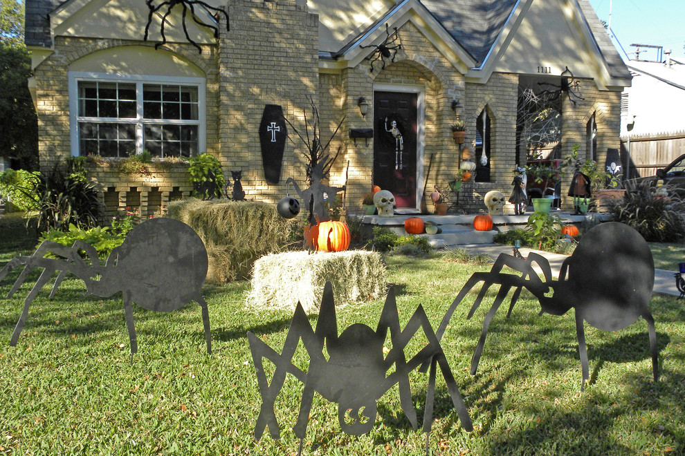 Print a bunch of spider silhouettes and cut them from a plywood sheet. Next, paint them black and add to your front yard's decor.