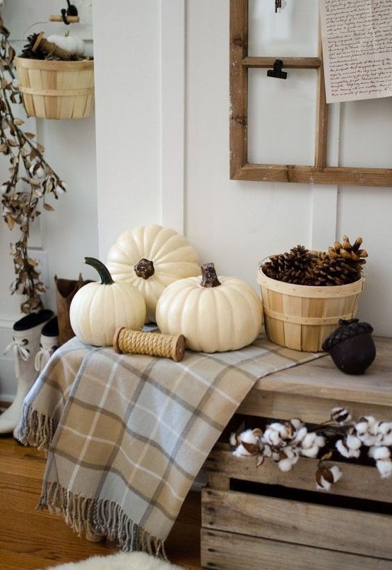 rustic entryway decor with cotton branches, pinecones, white pumpkins and a plaid runner for a cozy and rustic Thanksgiving feel