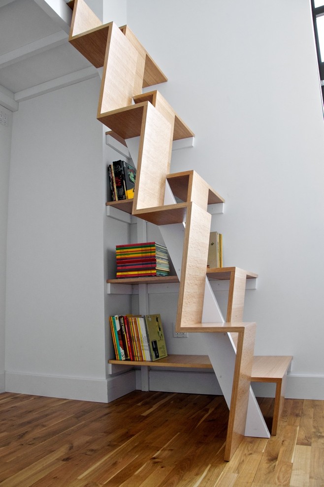 These modern and creative stairs are safe to climb and spatially efficient. The ope sides provide grip locations. The geometric design looks quite interesting and minimal. (nC2 architecture llc)