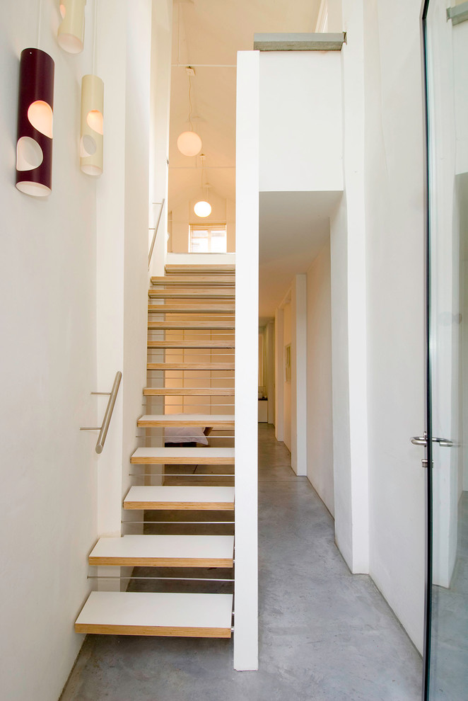Removing stair risers can make the staircase transparent so it won't look so bulky. (Threefold Architects) 