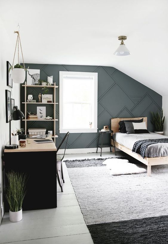 a contemporary teen bedroom with a 3D graphic wall, a black desk, a monochromatic rug and wooden furniture