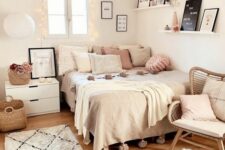 a cozy Scandinavian teen bedroom with a bed with neutral and pastel bedding, a nightstand, a rattan chair, a ledge gallery wall and pastel pillows