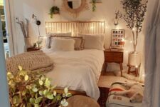 a pretty boho teen bedroom with a bed with a metal headboard, nightstands, potted plants, a dog bed, a jute pouf