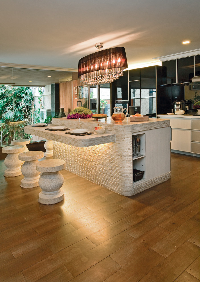 Marble strip mosaics looks gorgeous on this kitchen island and breakfast corner with lighting looks quite original