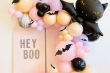 a Halloween kids’ party decoration with pastel balloons and a black balloon cat is amazing for celebrating