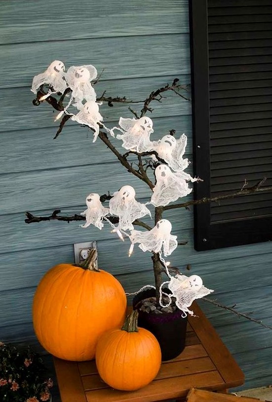 a Halloween tree decorated with cheesecloth ghosts with balloons inside is a fun idea for a kids' party
