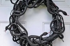 a black vine and faux snake wreath is a fantastic idea for Halloween, make one fast and easily using dollar store supplies