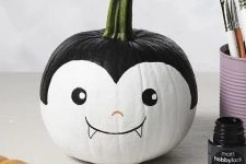 a cute and funny little monster pumpkin made using paints is a lovely solution for Halloween