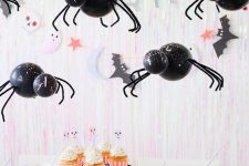 a fun and cute Halloween kids’ table setting with balloon spiders, letters, ghost cards, bat straws and cupcakes