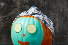a funny no carved Halloween pumpkin with a face mask, cucumber slices and a head wrap is a lovely and cute idea