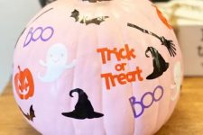 a pink pumpkin with ghosts, pumpkins, bats, witches’ hats and brooms plus colorful letters is a cool solution