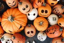 a simple yet cool halloween porch decor idea with lots of pumpkins