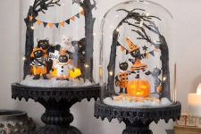 black vintage cloches with black cats dressed up, an orange pumpkin, black trees and black and orange banners