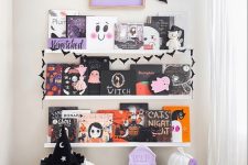 bold Halloween ledges with Halloween books and artwork, bats and an artwork is a cool idea for styling a kids’ room