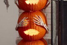 cool Halloween pumpkins stacked, with scary faces, eyes and skeleton hands are fun and cool for Halloween decor