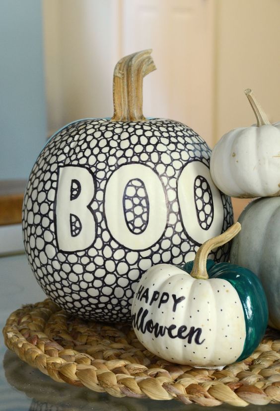 cool white pumpkins decorated with sharpies and with bright paint are amazing for Halloween and look chic