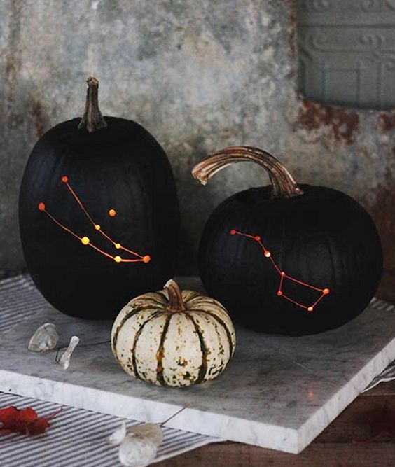 matte black constellation pumpkins are adorable for Halloween and look veyr stylish and bold, they arne't scary at all and you may use them just in the fall, too