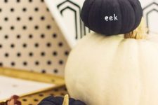 mini black pumpkins with letters are a chic and fresh modern idea to decorate your Halloween space
