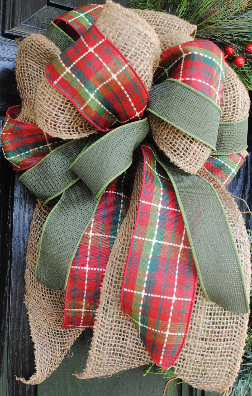 Mixing burlap with evergreen pine, cranberries and plaid ribbon is a great idea for a DIY rustic, natural-looking Christmas wreath.