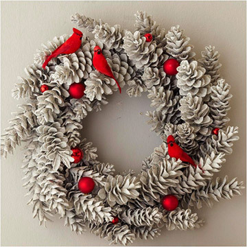 Snowy pinecones glued together is a great base for a DIY wreath. Just add some red pops of color, like these faux cardinals, to make a great Xmas wreath.